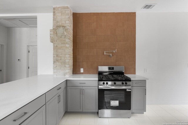 1144 Denver, San Antonio, TX 78210 - kitchen featuring stainless steel range with gas stovetop, gray cabinetry, and light countertops
