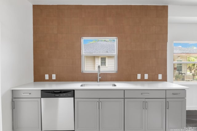 1144 Denver, San Antonio, TX 78210 - kitchen featuring dishwasher, gray cabinets, a sink, light countertops, and tile walls