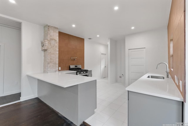 1144 Denver, San Antonio, TX 78210 - kitchen with a sink, gas range, light countertops, recessed lighting, and a peninsula