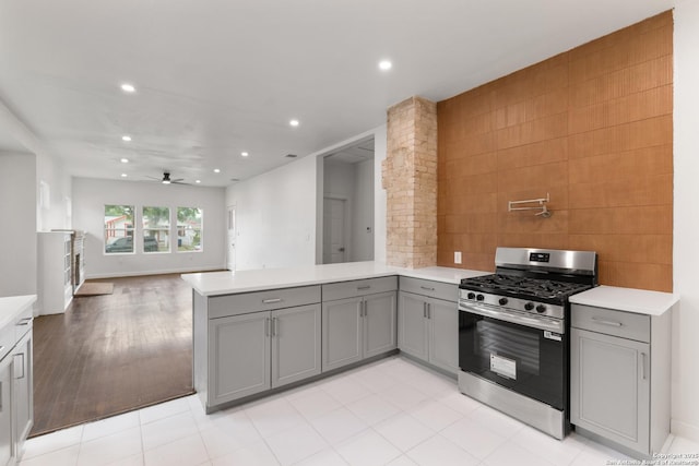 1144 Denver, San Antonio, TX 78210 - kitchen featuring gas stove, gray cabinets, a peninsula, light countertops, and recessed lighting