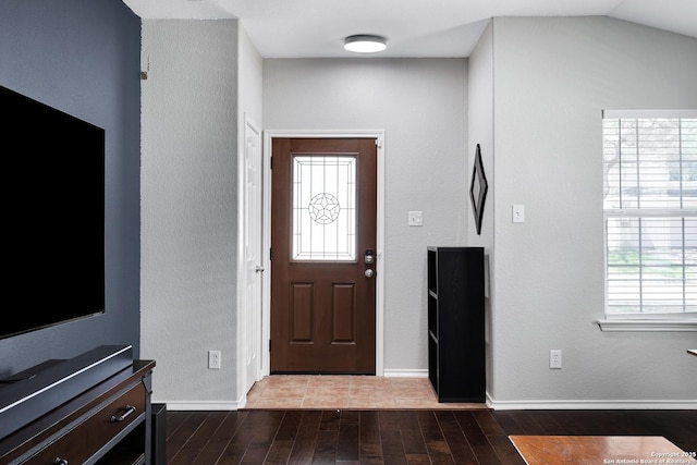 entryway with dark wood-style floors and baseboards