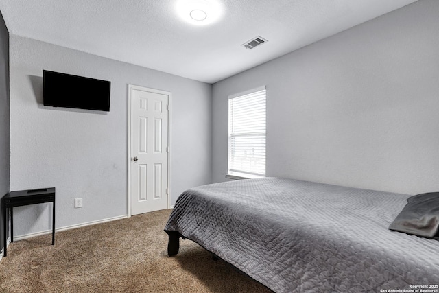 carpeted bedroom featuring baseboards