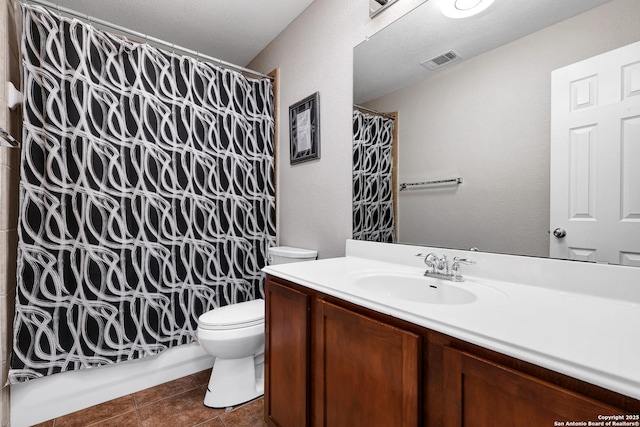 bathroom with toilet, tile patterned flooring, vanity, and shower / bathtub combination with curtain