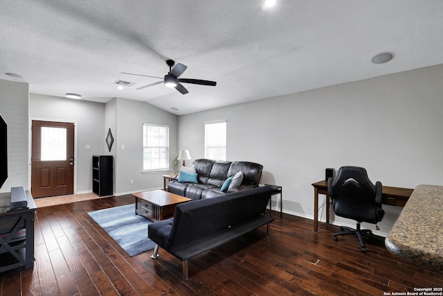 living area with a ceiling fan, hardwood / wood-style flooring, a textured ceiling, lofted ceiling, and baseboards