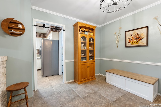 hallway featuring ornamental molding, a chandelier, and baseboards
