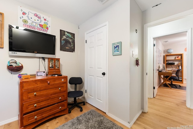 foyer entrance featuring light wood-style floors and baseboards
