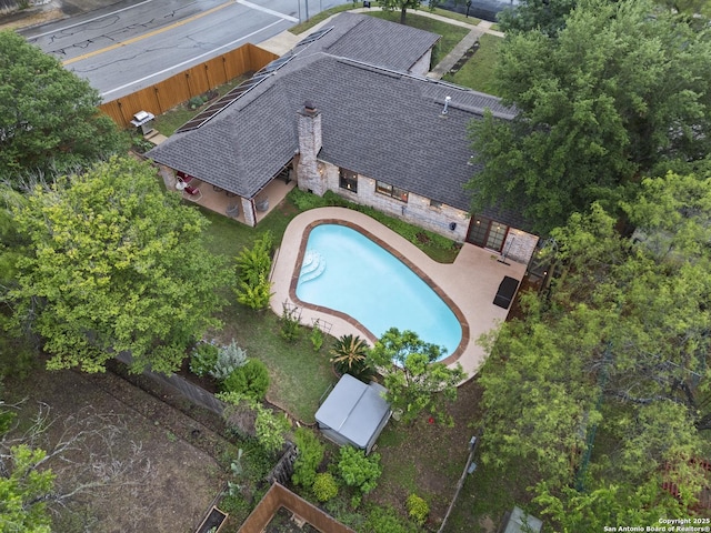 view of subject property with a pool