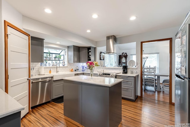 28426 Quadrille Ln, Boerne, TX 78015 - kitchen with appliances with stainless steel finishes, gray cabinetry, island range hood, a sink, and recessed lighting