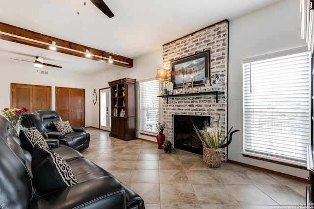 28426 Quadrille Ln, Boerne, TX 78015 - living area featuring ceiling fan, a brick fireplace, healthy amount of natural light, light tile patterned floors, and beamed ceiling