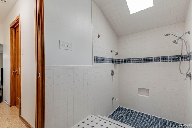 28426 Quadrille Ln, Boerne, TX 78015 - full bath with tiled shower, vaulted ceiling, and tile walls