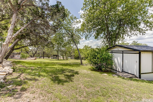 28426 Quadrille Ln, Boerne, TX 78015 - view of green lawn featuring an outbuilding and a storage unit