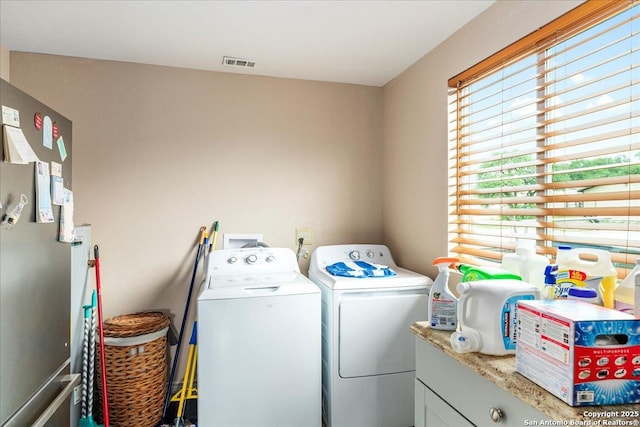 205 Montrose, Liberty Hill, TX 78642 - laundry area featuring washer and dryer and cabinet space