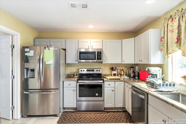 205 Montrose, Liberty Hill, TX 78642 - kitchen with appliances with stainless steel finishes, recessed lighting, light stone countertops, and light tile patterned floors