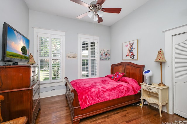 bedroom featuring multiple windows, wood finished floors, ceiling fan, and baseboards
