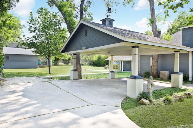 view of community with a lawn and driveway