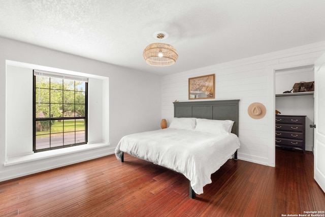 306 Chaparral Crk, Boerne, TX 78006 - bedroom featuring a spacious closet, wood finished floors, and a closet