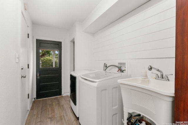 306 Chaparral Crk, Boerne, TX 78006 - laundry room with light wood finished floors and independent washer and dryer