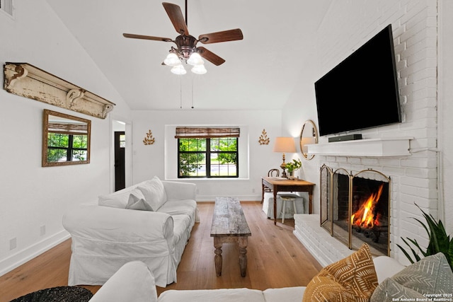 306 Chaparral Crk, Boerne, TX 78006 - living room with vaulted ceiling, ceiling fan, wood finished floors, healthy amount of natural light, and a brick fireplace