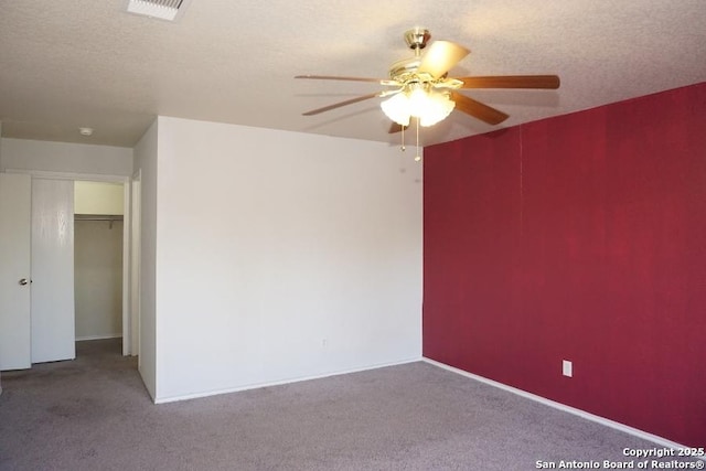 empty room with ceiling fan and carpet flooring