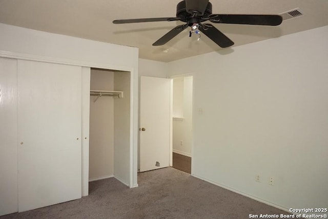 unfurnished bedroom with carpet floors, a closet, a ceiling fan, and baseboards