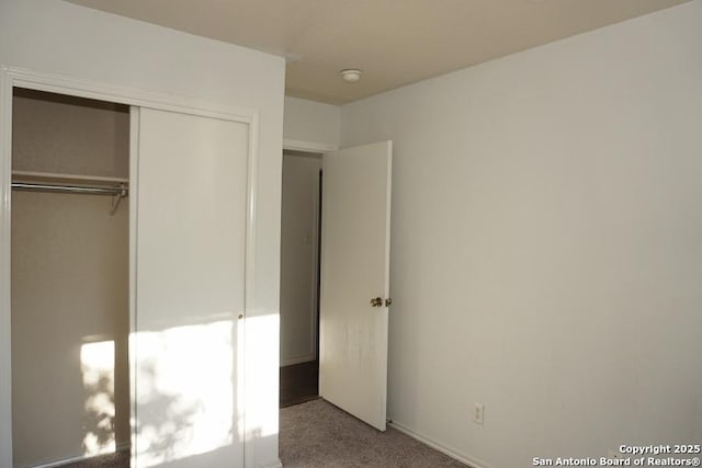 unfurnished bedroom with carpet and a closet