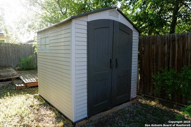 view of shed with a fenced backyard