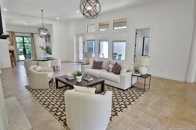 living room with a chandelier, recessed lighting, and baseboards