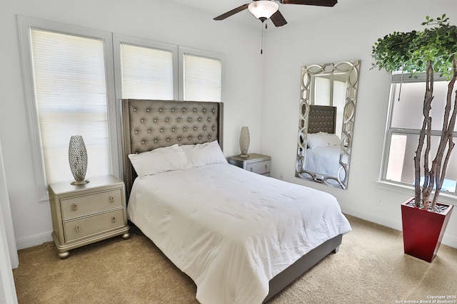carpeted bedroom with baseboards and ceiling fan