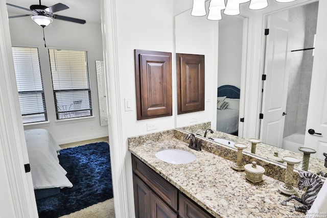 ensuite bathroom with ceiling fan and vanity
