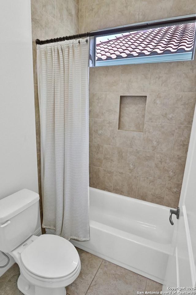 full bath featuring tile patterned floors, toilet, and shower / tub combo