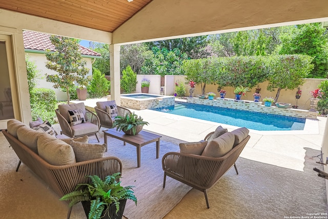 view of swimming pool with a fenced backyard, a patio, and a pool with connected hot tub