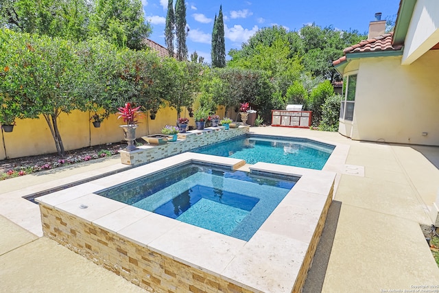 view of pool featuring an in-ground hot tub, a fenced backyard, and a patio
