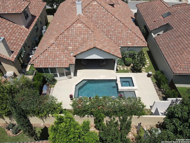 aerial view of property and surrounding area featuring a pool area