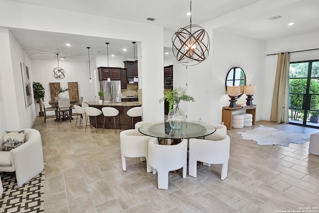 dining space with a chandelier and recessed lighting