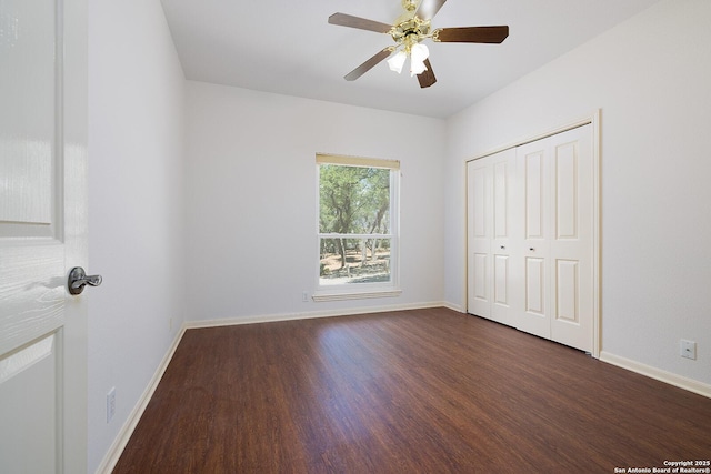 552 Mountain Oaks, Canyon Lake, TX 78133 - unfurnished bedroom with dark wood-type flooring, baseboards, a closet, and a ceiling fan