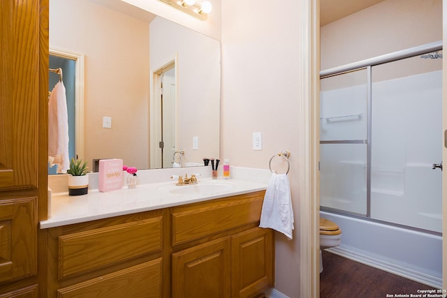 552 Mountain Oaks, Canyon Lake, TX 78133 - full bath with toilet, vanity, bath / shower combo with glass door, and wood finished floors