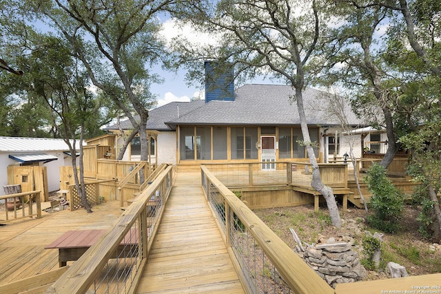 552 Mountain Oaks, Canyon Lake, TX 78133 - rear view of house with a sunroom, roof with shingles, a wooden deck, and a chimney