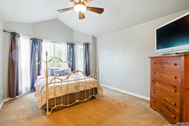 bedroom featuring light colored carpet, lofted ceiling, baseboards, and a ceiling fan