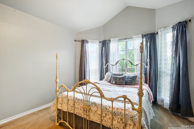 bedroom with carpet, vaulted ceiling, and baseboards