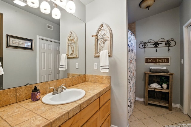 bathroom featuring tile patterned flooring and vanity