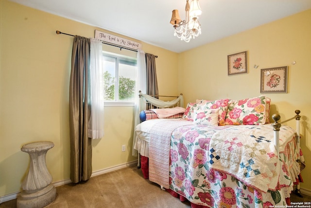 carpeted bedroom featuring baseboards and a chandelier