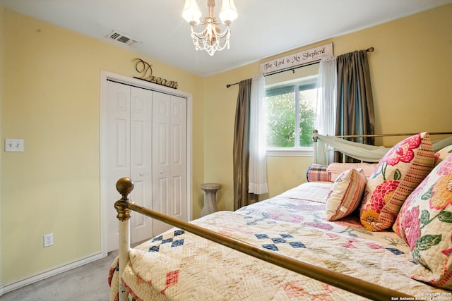bedroom featuring carpet, a closet, a chandelier, and baseboards