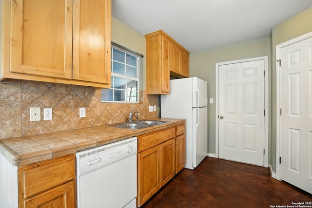 kitchen featuring white appliances, a sink, tasteful backsplash, concrete floors, and tile countertops