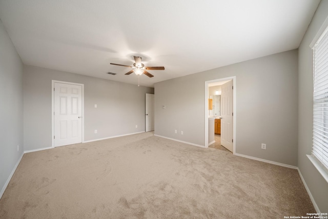 unfurnished bedroom featuring baseboards, carpet floors, and multiple windows