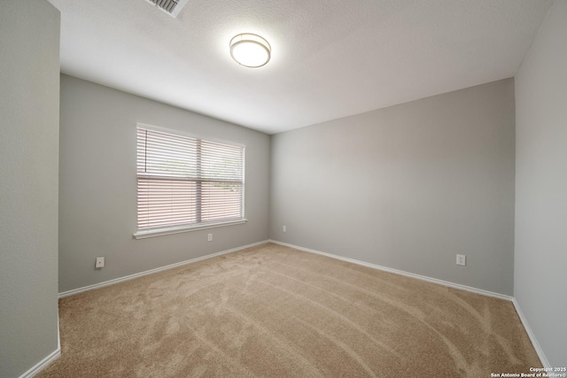 carpeted empty room with baseboards