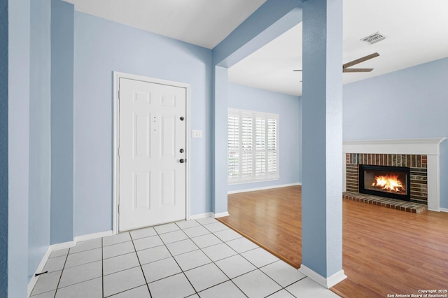 8818 Sarasota Woods, San Antonio, TX 78250 - foyer with light wood-style floors, a brick fireplace, ceiling fan, and baseboards