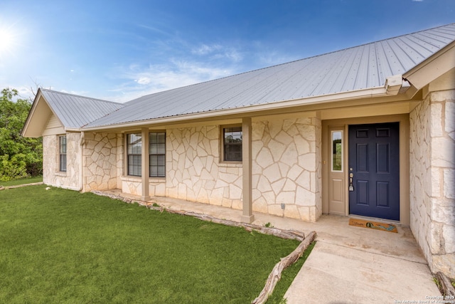 3010 Skyline, Canyon Lake, TX 78133 - entrance to property with metal roof, stone siding, and a lawn