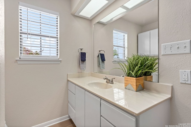 3010 Skyline, Canyon Lake, TX 78133 - bathroom with vanity, a textured wall, and baseboards