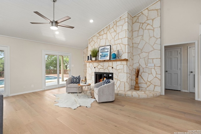 3010 Skyline, Canyon Lake, TX 78133 - living room with lofted ceiling, ceiling fan, wood finished floors, a stone fireplace, and baseboards