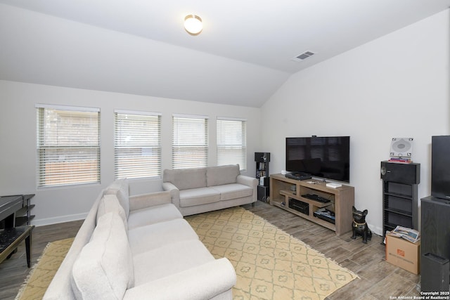 1710 Briar Spg, San Antonio, TX 78245 - living area featuring wood finished floors, vaulted ceiling, and baseboards